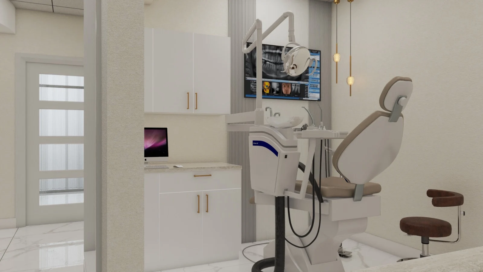 Dental American Group — Treatment room seen from the doorway, with white cabinets, brass pulls and two brass pendant lights