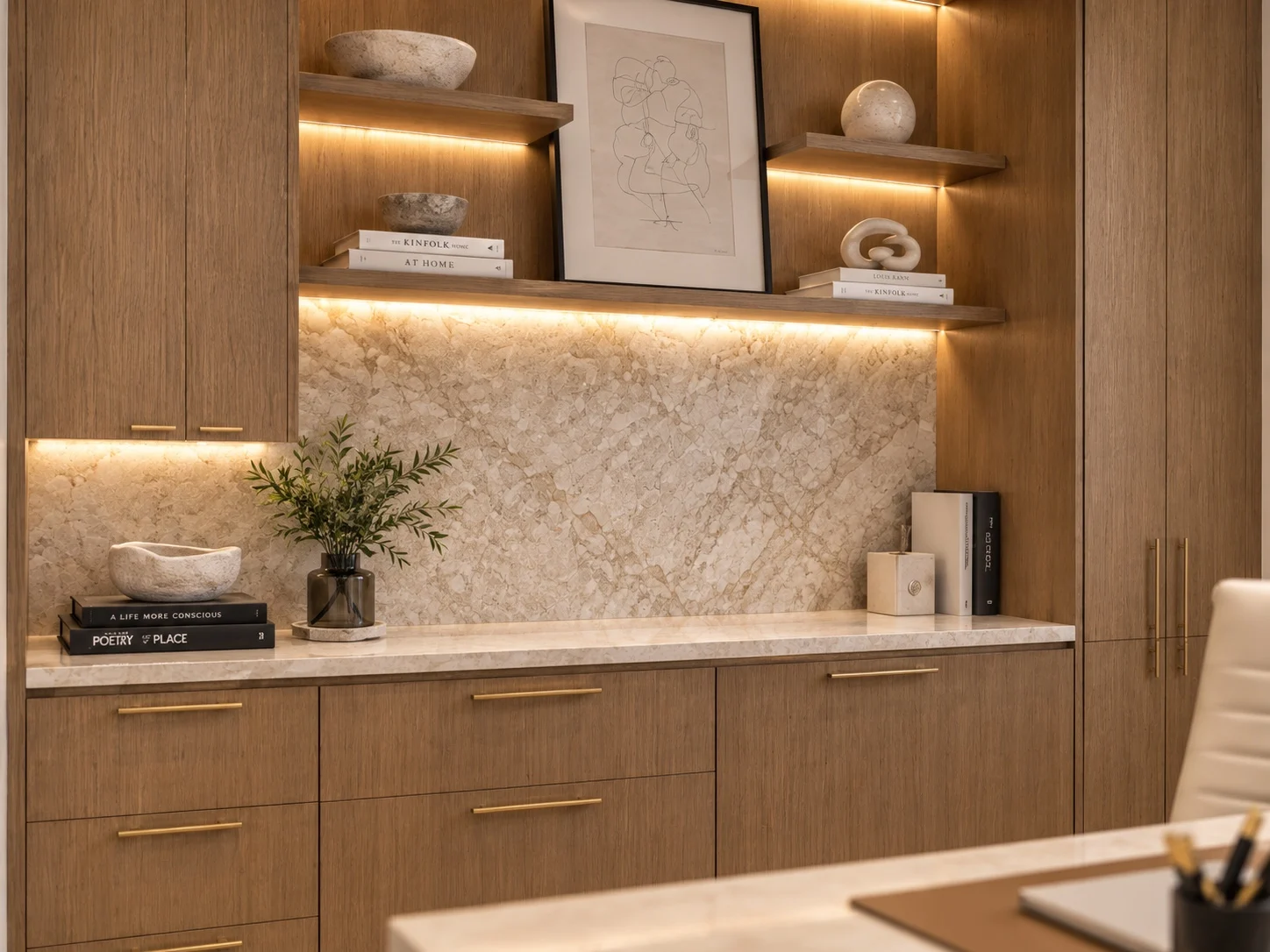 Park Avenue Dental — Detail of wood cabinetry with lit floating shelves, a line drawing and a stone-look backsplash