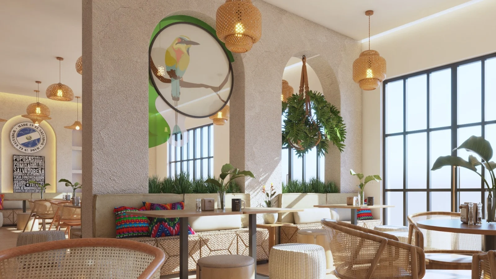 Pupusería Delicias de Maíz — Banquettes with bright cushions below a textured wall with arches, a round bird artwork and a hanging plant