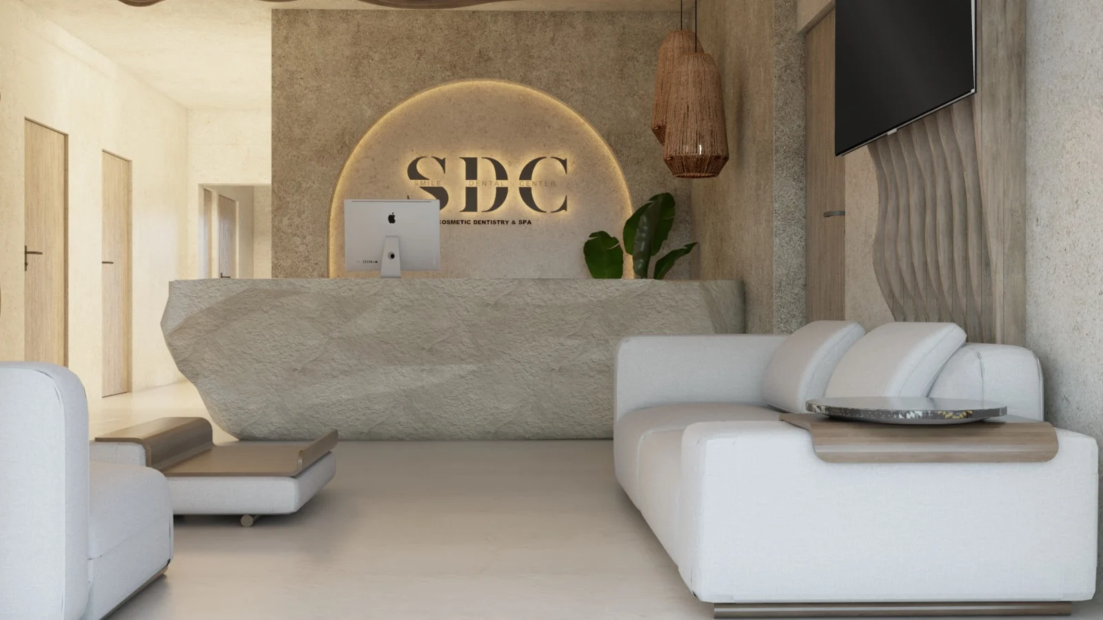 SDC — Smile Dental Center — Reception seen head-on, with the “SDC” logo in a backlit arch behind a rough stone-look desk