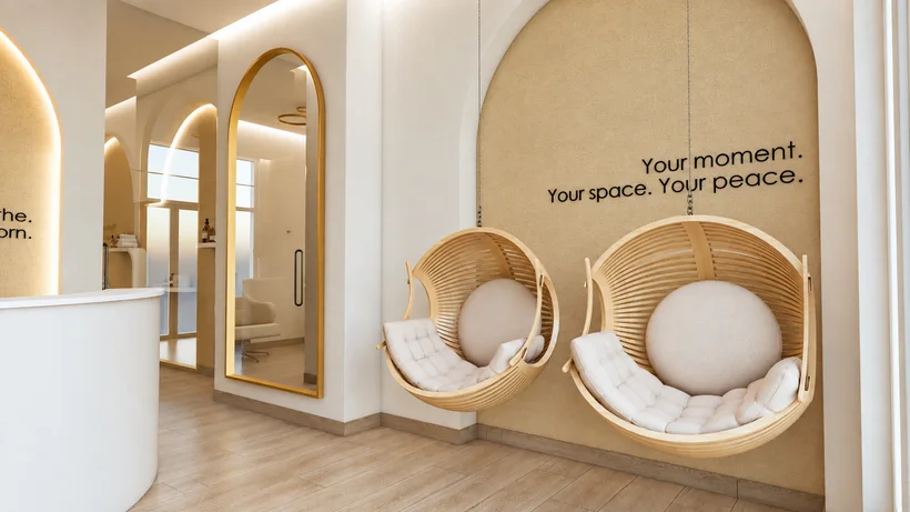 Soji Medspa — Lounge where two hanging wood-slat pod chairs sit under “Your moment. Your space. Your peace.” in an arched niche